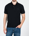 Polo in piquet con logo ricamato tono su tono lato cuore