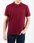Polo in piquet con logo ricamato tono su tono lato cuore