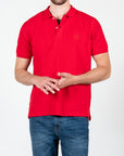 Polo in piquet con logo ricamato tono su tono lato cuore