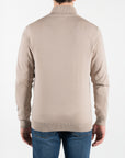 Maglione con mezza zip e ricamo lato cuore della firma del brand